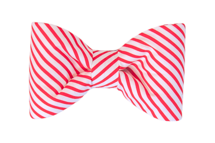Holiday-inspired red striped bow tie with bold diagonal lines, like that of a candy cane, and dramatic pointed ends. Perfect for attaching onto a dog’s collar to add cheerful Christmas charm.