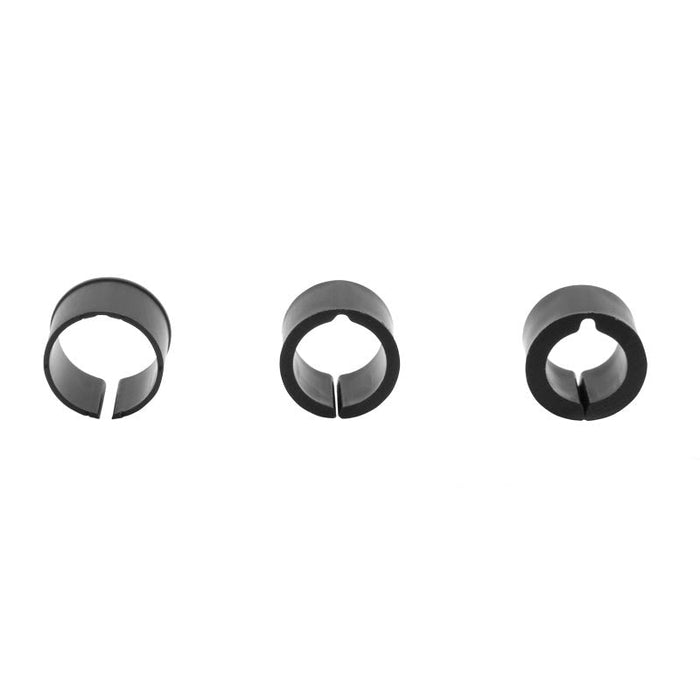Three black, circular plastic clips with a single slit in each are evenly spaced on a white background, shown as components of the Handlebar Spacer Kit or as handlebar adapter rings.