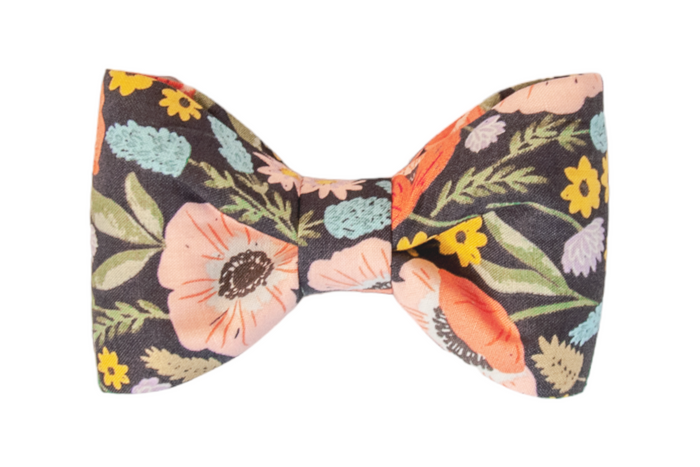 This fabric dog bow tie pops against its dark background with bright blossoms, pastel florals, and leaves—perfect for pups who like their style to bloom.