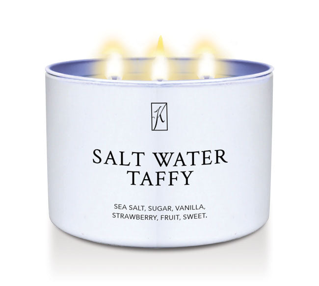 Kringle Candle Salt water taffy candle tin with a white lid on a white background