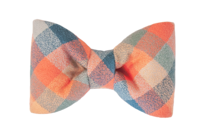 Flannel bow tie in a diamond-check plaid pattern blending pastel tones, with rounded edges and precise folds that create a balanced, structured shape. The perfect addition to your dogs fall wardrobe.