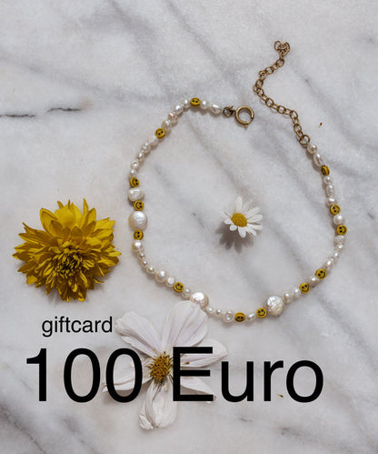 A Berlin-made necklace featuring delicate flowers accompanied by a €100 gift card for WALD Berlin jewelry.