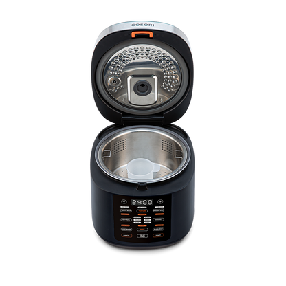 Top-down view into the open Cosori Rice Cooker showing the inner heating plate and lid structure.