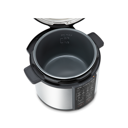 Top-down view into the open 6-quart pressure cooker pot, showing the nonstick interior coating