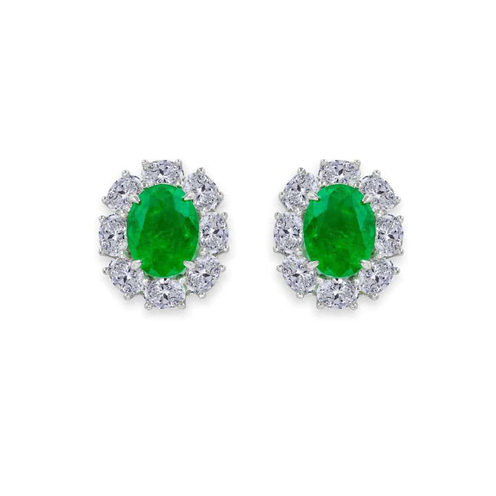 From the Victoria Collection by Anna Zuckerman Luxury, Sterling Silver Oval Emerald Green CZ Halo Stud Earrings.  Classic 2 carat oval emerald green or sapphire blue crystalline stud with diamond white crystalline halo 8 tcw set in platinum plated sterling silver 925.