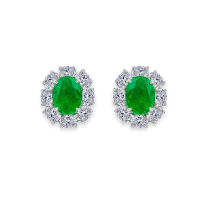 From the Victoria Collection by Anna Zuckerman Luxury, Sterling Silver Oval Emerald Green CZ Halo Stud Earrings.  Classic 2 carat oval emerald green or sapphire blue crystalline stud with diamond white crystalline halo 8 tcw set in platinum plated sterling silver 925.