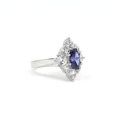From the Victoria Collection by Anna Zuckerman, Elegant 1.5 carat sapphire blue crystalline oval in a halo of round diamond white round crystalline 5 tcw set in platinum plated sterling silver 925