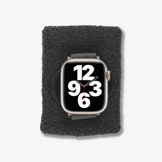 Front close-up of Apple Watch Sportband showing black plush terry cloth texture and large numeric watch face on white background