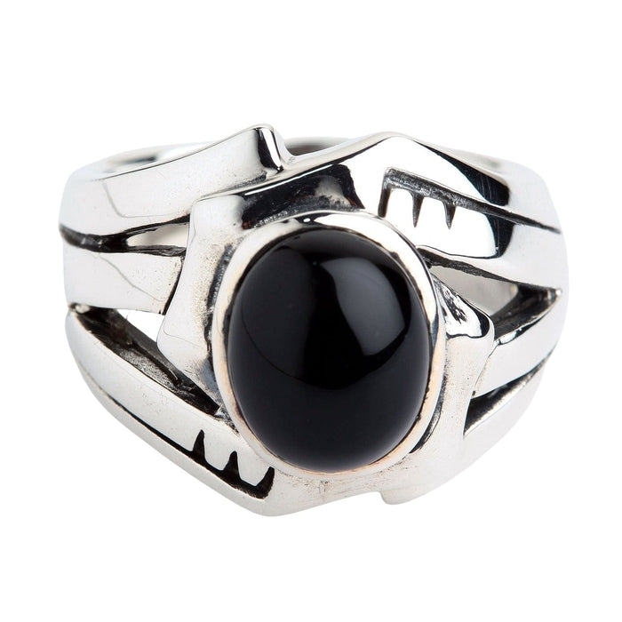 Close-up highlighting the flat black onyx stone centered within a wide sterling silver band featuring abstract cutouts.