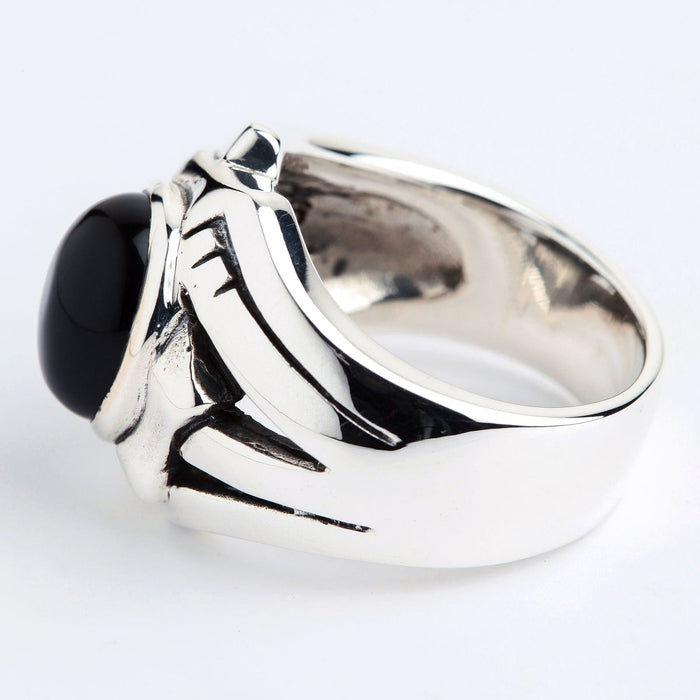 Rear angled perspective showcasing the polished inner band and thick sterling silver shank of the rocker ring.
