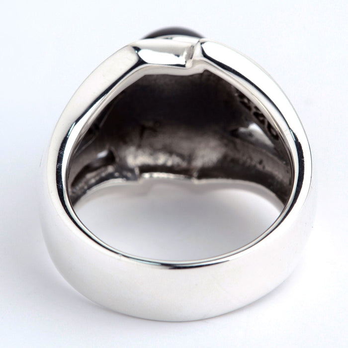 Bottom view revealing the solid sterling silver band and the textured interior cavity beneath the black stone setting.
