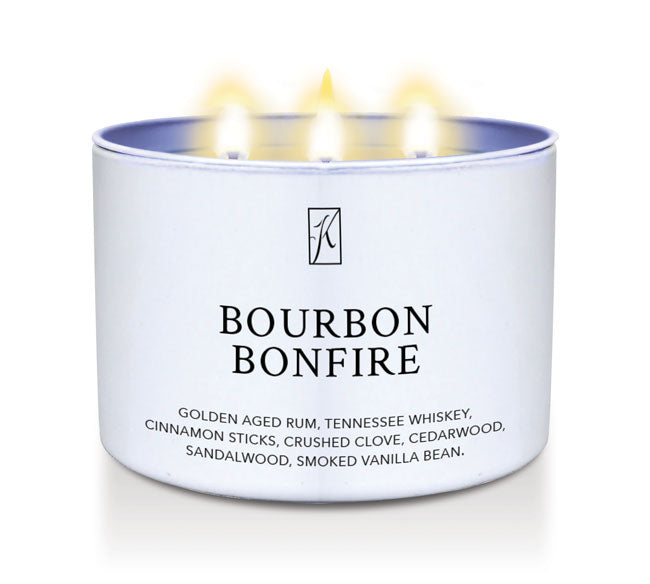Candle in a white container labeled 'Bourbon Bonfire' with flames on a white background