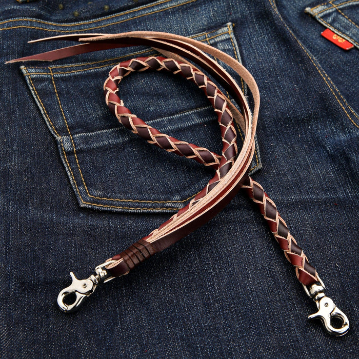A detailed shot of the polished silver lobster clasps on the black and brown braided leather wallet chain.