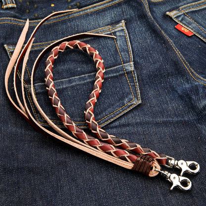 A close-up of the long leather braid of the biker wallet chain, showing the black and brown two-tone zigzag pattern.
