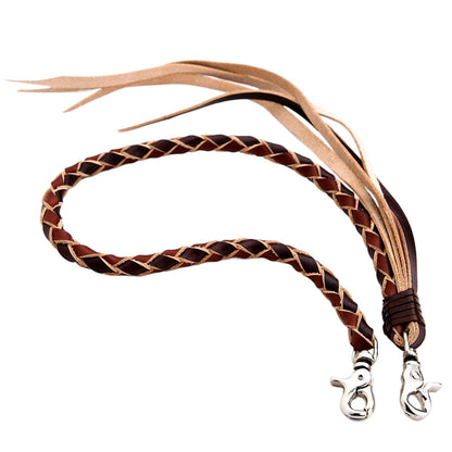 Studio shot of the handcrafted braided leather wallet chain in black and brown, showing the leather tassels and double lobster clips.