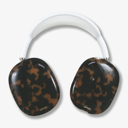 Close up top view of Brown Tort AirPods Max cover showing tortoiseshell ear cups and white padded headband on light background