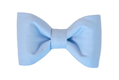 Simple light blue dog bow tie with a classic symmetrical shape, made from soft cotton fabric and designed to attach to a collar.