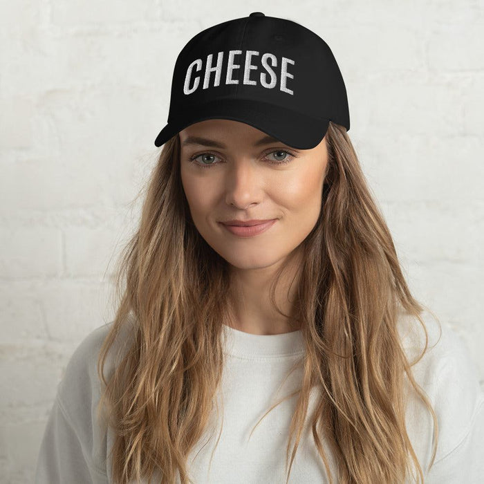 Black dad hat with "CHEESE" embroidered on the front, low profile design, adjustable strap, unstructured 6-panel.