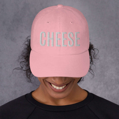 Pink "CHEESE" hat with embroidered text, featuring a low-profile dad hat style with an adjustable strap and curved visor.