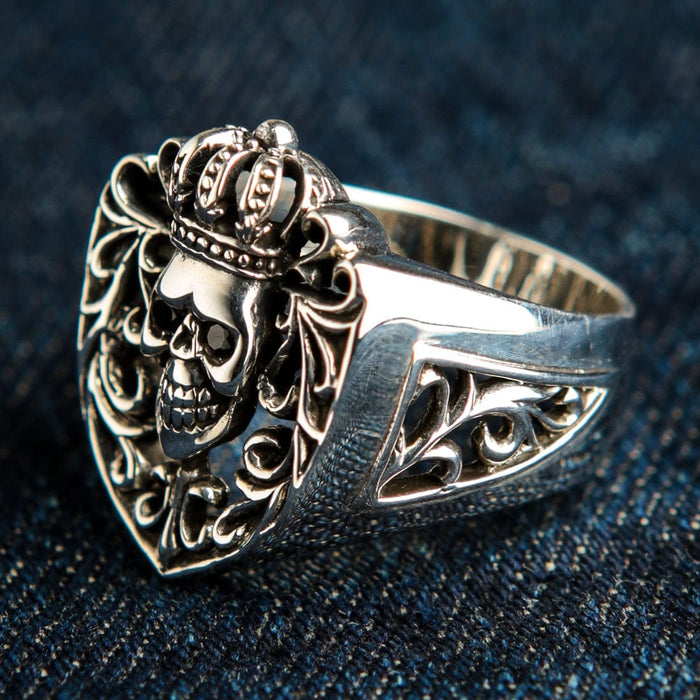 Angled close-up showing the intricate cut-out gothic scrollwork on the side band of the solid sterling silver biker ring.