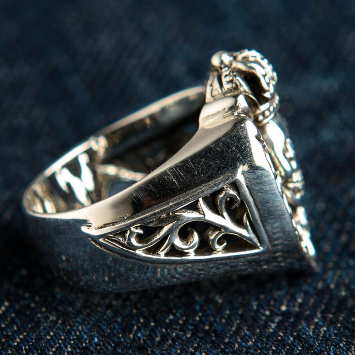 Rear angled view highlighting the tapered polished silver shank and hollow interior of the heavy biker ring.