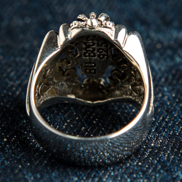 Direct look inside the hollow back of the crowned skull face, revealing the 925 sterling silver hallmark and maker's stamp.