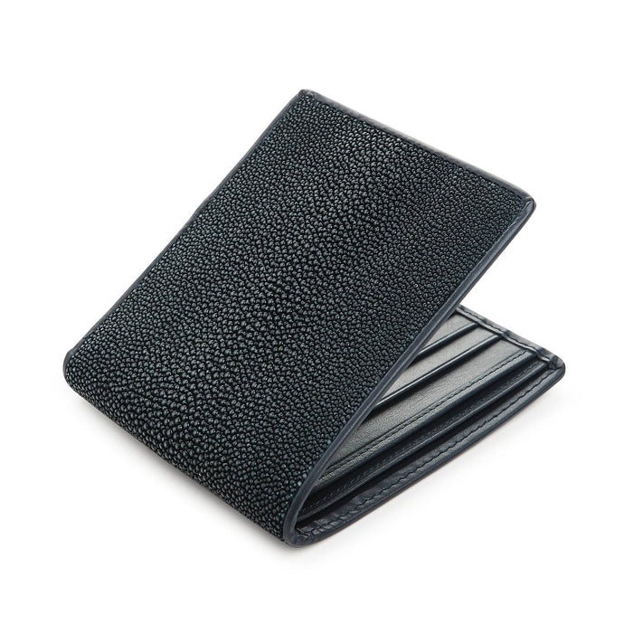 Navy shagreen billfold opened at an angle, matching blue stitching along the card slots inside.