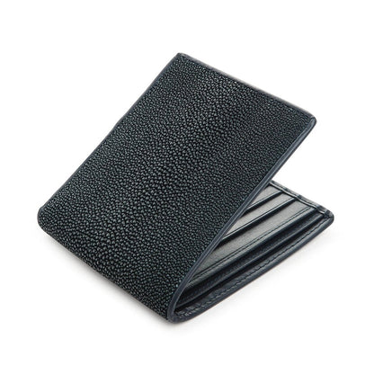 Navy shagreen billfold opened at an angle, matching blue stitching along the card slots inside.