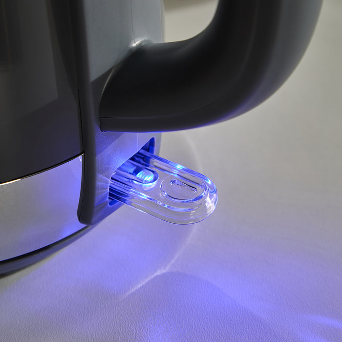 Close-up of a black kettle with a blue light on a white surface