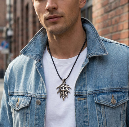 Man wearing large silver spike cross pendant on a black leather cord