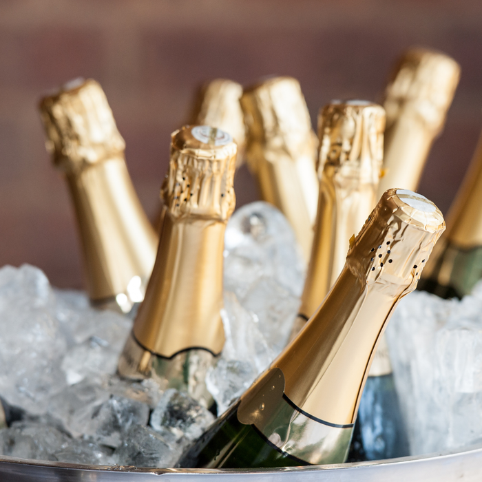 Champagne bottles with gold caps in a bucket of ice