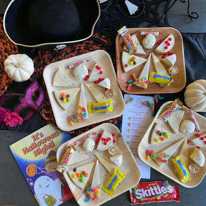image of multiple plates of halloween candy and scheese tasting plates