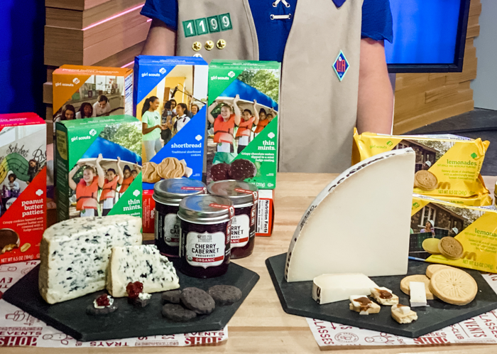Girl Scout cookies and cheese pairing event display with various cheeses, cookies, and preserves.