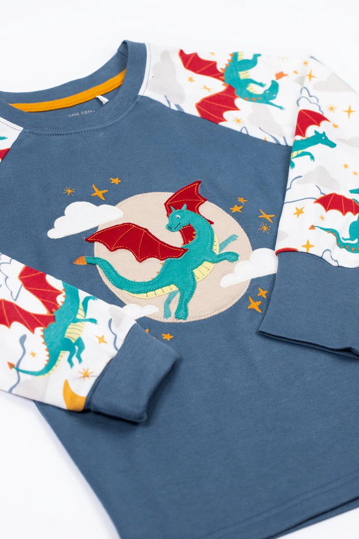 Children's pajama set with dragon design on a white background