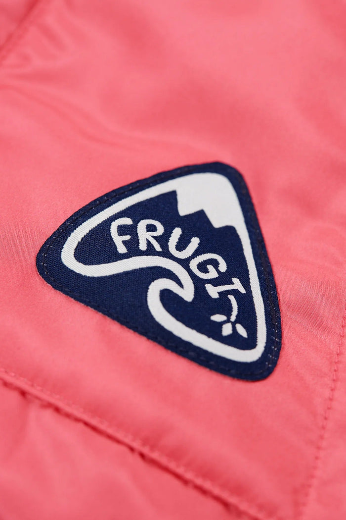 Close-up of a pink jacket with a 'Frugi' logo on a pink background