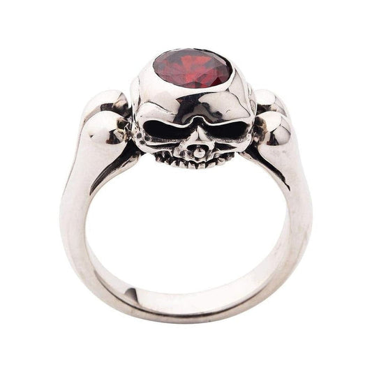 A prime example of premium gothic jewelry: a solid silver ring with skulls, bones, and a deep red garnet.