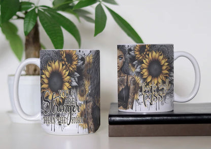Golden Petals Unbreakable Spirit white ceramic coffee mug with golden sunflowers and You Are Stronger Than the Storm quote.