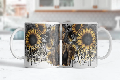 Inspirational sunflower coffee mug featuring golden flowers and You Are Stronger Than the Storm message.
