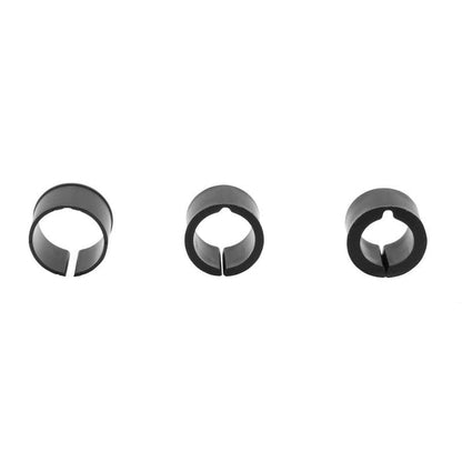 Three black, circular plastic clips with a single slit in each are evenly spaced on a white background, shown as components of the Handlebar Spacer Kit or as handlebar adapter rings.