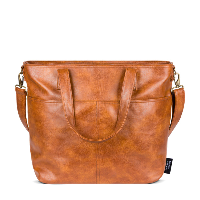 Brown leather tote bag with cognac and tan tones, featuring natural variations in honey and burnt caramel hues throughout the material.