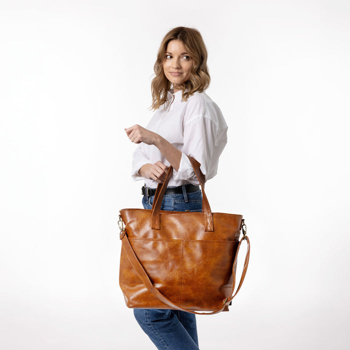 Cognac leather texture with neutral white and cream background tones, accented by medium to dark denim blue