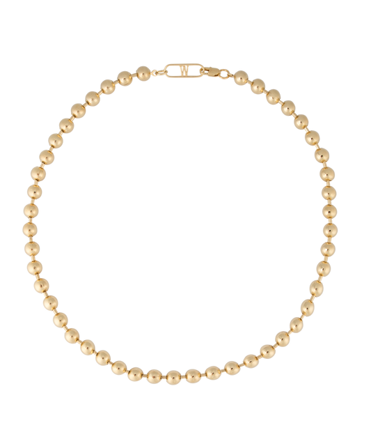 The Harry Necklace Gold by WALD Berlin, showcasing a circular arrangement of striking gold beads made from recycled gold, is elegantly displayed against a black background.