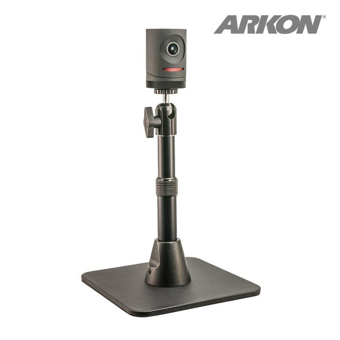 A compact black Mevo camera sits on the Height-Adjustable Camera Desk Stand (7.5 to 9.75 inches tall), shown with a square base on a white background. ARKON branding appears in the top right corner, ideal for live streaming setups.
