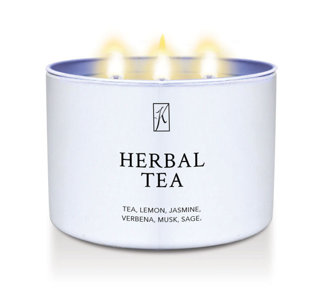 Candle in a white container labeled 'Herbal Tea' with a logo on a white background