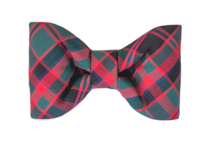 A classic dog bow tie in festive plaid, featuring neatly pleated sides and a symmetrical shape. Made from classically festive fabric with a structured cinched center, perfect for adding holiday cheer to your pup's wardrobe.