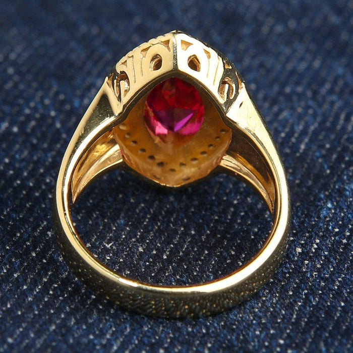 Reverse angle exposing the intricate gold-plated undergallery cutouts and the back of the marquise ruby setting.