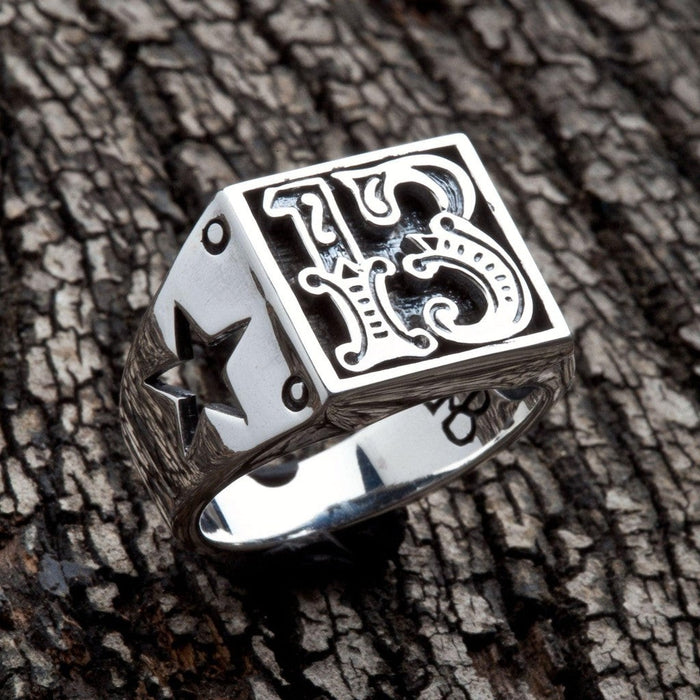 Top-angle view of the Number 13 sterling silver biker ring showing raised gothic numerals and cut-through star on shank
