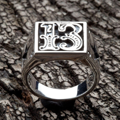 Straight-on view highlighting deep hand-applied oxidation behind the gothic 13 numerals