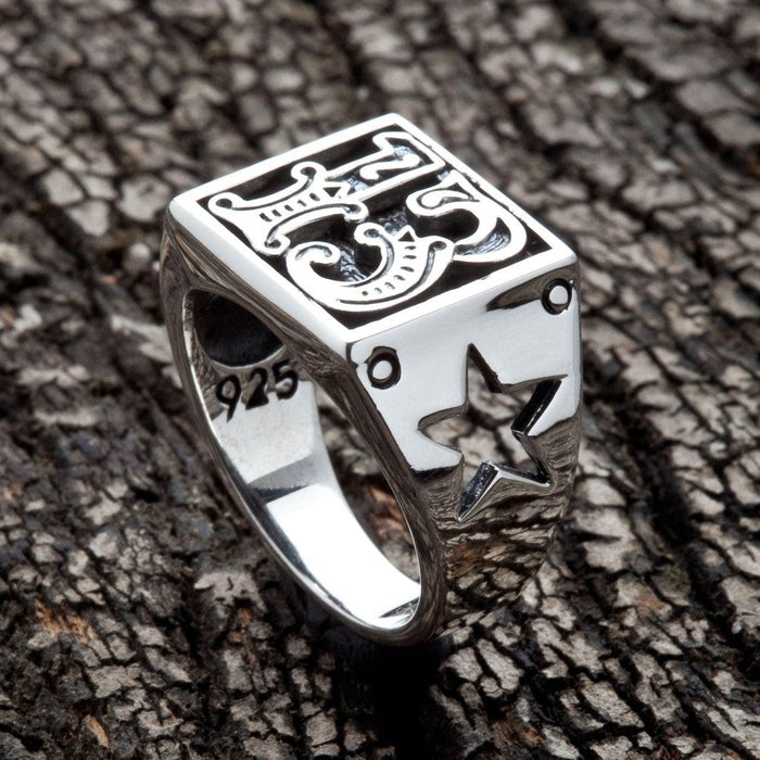Angled left side showing five-point star cut through the sterling silver shank with visible skin-through effect