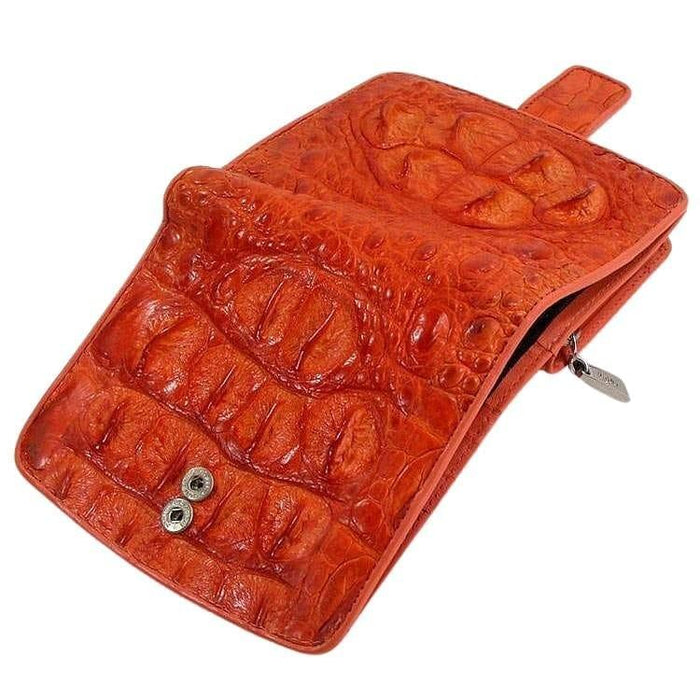 Partially open orange crocodile hornback wallet showing button snap fastener and side zipper pocket with silver pull tab